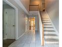 Bright entryway featuring tiled floors, a staircase, and access to other rooms in the home at 1464 Claredon Dr, Lawrenceville, GA 30043