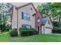 Charming two-story home with a brick accent, attached garage, and a well-maintained lawn at 1464 Claredon Dr, Lawrenceville, GA 30043
