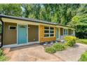 Exterior shot of home with a blue door and wood and stone accents at 2935 Catalina Dr, Decatur, GA 30032