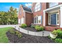 Lovely landscaped front yard with blooming flowers and brick facade on a two-story home at 5204 Tealing Ne Dr, Roswell, GA 30075