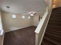 Bright living room featuring wood floors and a staircase leading to the second floor at 5345 Mountain Top Pl, Cumming, GA 30041