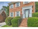 Close up of the front of this brick home with stairs to the door and manicured bushes at 3196 Henderson Walk, Atlanta, GA 30340