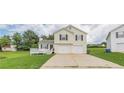 Charming two-story home with a two-car garage, black shutters, and a small deck at 341 Brookside Dr, Mcdonough, GA 30253