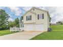 Charming two-story home with a two-car garage, black shutters, and a deck at 341 Brookside Dr, Mcdonough, GA 30253