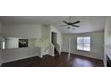 Open-concept living space boasting hardwood floors, neutral walls, and a view of the kitchen at 341 Brookside Dr, Mcdonough, GA 30253