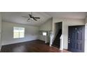 Bright living room featuring hardwood floors, ceiling fan and access to the staircase at 341 Brookside Dr, Mcdonough, GA 30253