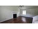 Spacious living room with a fireplace, high ceilings, and rich hardwood flooring at 341 Brookside Dr, Mcdonough, GA 30253