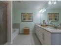 Bathroom featuring dual sinks, granite countertops, and a large mirror at 5535 Bright Cross Way, Suwanee, GA 30024