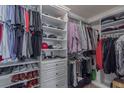 Walk-in closet with custom shelving for shoes and folded clothing at 5535 Bright Cross Way, Suwanee, GA 30024