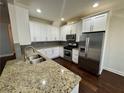 Modern kitchen featuring stainless steel appliances and granite countertops at 5535 Bright Cross Way, Suwanee, GA 30024