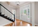 Bright foyer with hardwood floors, staircase, and decorative glass accents on the front door at 1096 Polo Club Nw Dr, Marietta, GA 30064