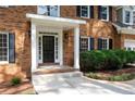 Inviting front door with white columns, decorative windows, and lush landscaping at 1096 Polo Club Nw Dr, Marietta, GA 30064