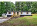 Inviting single-story home featuring wood accents and a well-maintained lawn at 12208 Buchanan Hwy, Temple, GA 30179