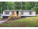 Well-kept single-story home with a cozy porch and manicured landscaping at 12208 Buchanan Hwy, Temple, GA 30179
