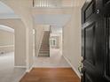 Inviting foyer with hardwood flooring, a staircase, and a view into the living spaces at 740 Orchard Ct, Atlanta, GA 30328