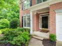 Close up view of the home's brick facade, front door, and manicured landscaping at 740 Orchard Ct, Atlanta, GA 30328