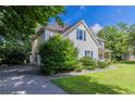 Side view of a two-story house with blue shutters, green landscaping, and paved driveway at 1615 Burnt Oak Way, Dacula, GA 30019