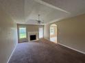 Living room features a fireplace and ceiling fan, windows offer natural light at 380 Paper Mill Rd, Lawrenceville, GA 30046