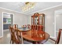 Elegant dining room featuring a crystal chandelier and traditional wooden furniture at 4619 Villa Chase Ne Dr, Marietta, GA 30068