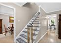 Bright foyer showcasing a staircase with decorative wrought iron railing, and plush carpeted steps at 4619 Villa Chase Ne Dr, Marietta, GA 30068