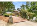 Long driveway surrounded by lush greenery leads to this beautiful home at 570 Matterhorn Way, Alpharetta, GA 30022