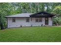 Stylish home exhibiting a well-kept lawn, and sleek, painted brick at 1733 Hollyhock Ter, Decatur, GA 30032