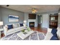 Cozy living room featuring a fireplace, hardwood floors, and a plush rug with nice furniture at 1696 Hunting Creek Dr Se, Conyers, GA 30013