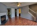 Inviting living room with hardwood floors, fireplace, staircase and entry to the bathroom and kitchen at 1696 Hunting Creek Dr Se, Conyers, GA 30013