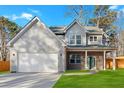 Charming two-story home featuring a gray exterior, two-car garage, well-kept lawn, and welcoming covered front porch at 4806 Forest Trl, Douglasville, GA 30135
