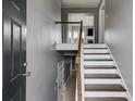 Inviting foyer with hardwood stairs and neutral gray walls, offering a glimpse into the home's interior at 4905 Martin Farms Dr, Powder Springs, GA 30127