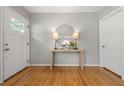 Bright foyer with hardwood floors, a stylish console table, and a round mirror at 839 Cardova Ne Dr, Atlanta, GA 30324