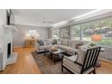 Cozy living room featuring a fireplace, neutral-toned sectional sofa, and abundant natural light at 839 Cardova Ne Dr, Atlanta, GA 30324