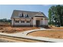 Newly constructed single-story home with sidewalk and grey shingles at 11 Butternut Way, Auburn, GA 30011
