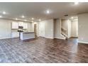Spacious living room featuring wood floors, recessed lighting, and an open floor plan concept that flows to kitchen at 11 Butternut Way, Auburn, GA 30011