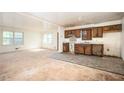 Open concept kitchen with classic wood cabinets adjacent to a spacious living area at 270 Bromack Se Dr, Atlanta, GA 30315
