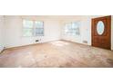 Bright living room features hardwood floors, large windows, and a classic wood door at 270 Bromack Se Dr, Atlanta, GA 30315