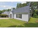Well-maintained home with a gray roof, vinyl siding, and a lush green lawn showcasing its curb appeal at 3530 Boulder Cir, Ellenwood, GA 30294