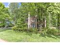 Charming brick two-story home with a well-manicured lawn and beautiful green trees at 4259 Arbor Club Dr, Marietta, GA 30066