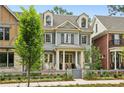 Charming two-story home with a landscaped yard, dormer windows, and a welcoming front porch at 105 Cumming St, Alpharetta, GA 30009