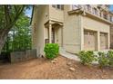 Beautiful brick townhome showcasing front porch, two-car garage, and lush green landscaping at 1636 Caswell Pkwy, Marietta, GA 30060