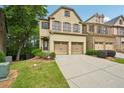 Charming brick townhome featuring a two-car garage, well-maintained landscaping, and inviting curb appeal at 1636 Caswell Pkwy, Marietta, GA 30060