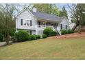 Inviting home featuring a well-kept lawn, gray siding, and a classic front porch at 350 Spring View Ct, Dallas, GA 30157