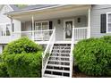 Close-up of a charming front porch with white railings and a decorative front door at 350 Spring View Ct, Dallas, GA 30157