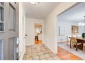 Welcoming entryway with tiled floor, opening to a dining room and kitchen with white cabinets at 4140 Candler Lake West Ne, Atlanta, GA 30319