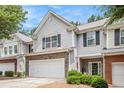 Beautiful exterior of a townhome with a two-car garage and inviting front porch at 461 Mountain View Ln, Woodstock, GA 30188