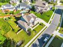 Expansive aerial view showcasing a home with a manicured lawn, a fenced backyard, and a neighborhood setting at , Kennesaw, GA 30152
