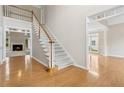 Open foyer with hardwood floors, staircase and view to the formal living room with fireplace at 1250 Parkview Nw Ln, Kennesaw, GA 30152
