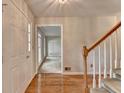 Inviting foyer featuring hardwood floors, a staircase, and a view into a bright, open living space at 1592 Walkway Ct, Lilburn, GA 30047