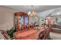 Formal dining room with elegant chandelier, china cabinet and seating for eight people at 4969 Truitt Ln, Decatur, GA 30035