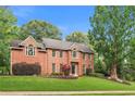 Beautiful two-story brick home with manicured lawn at 100 Parkerwood Way, Alpharetta, GA 30022